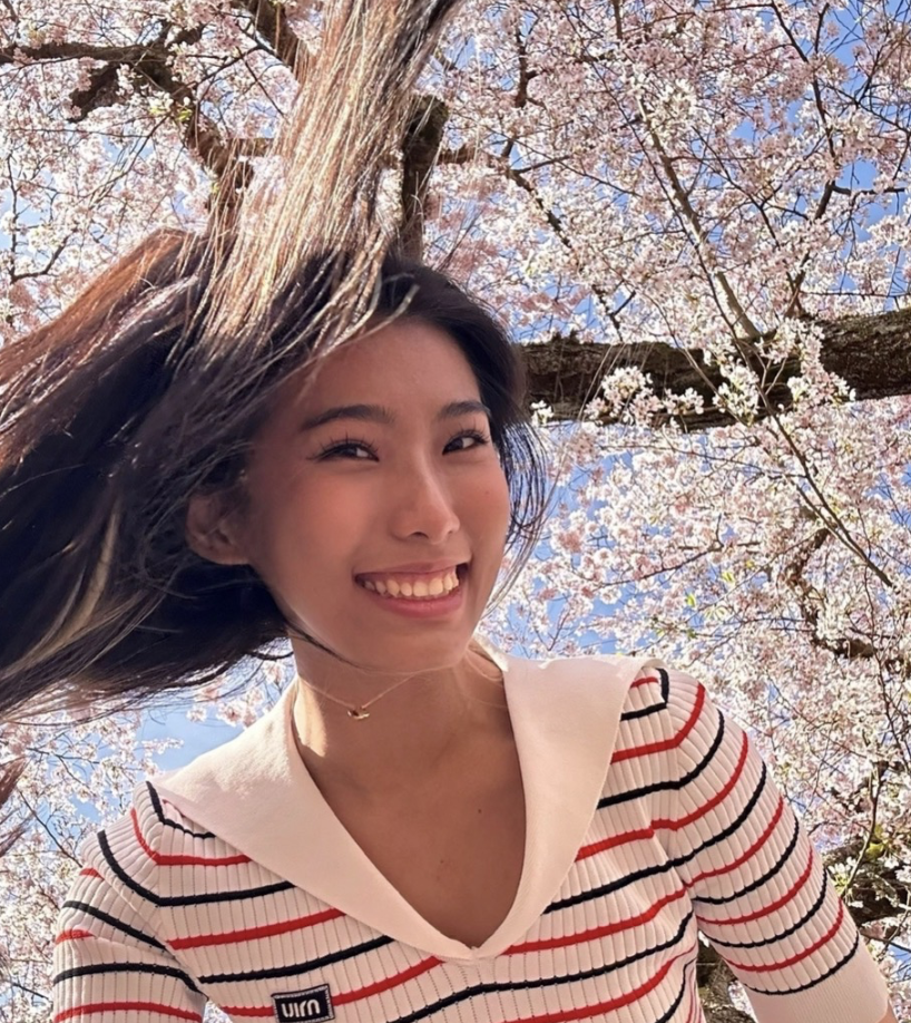 Ruyan Li beneath cherry blossoms